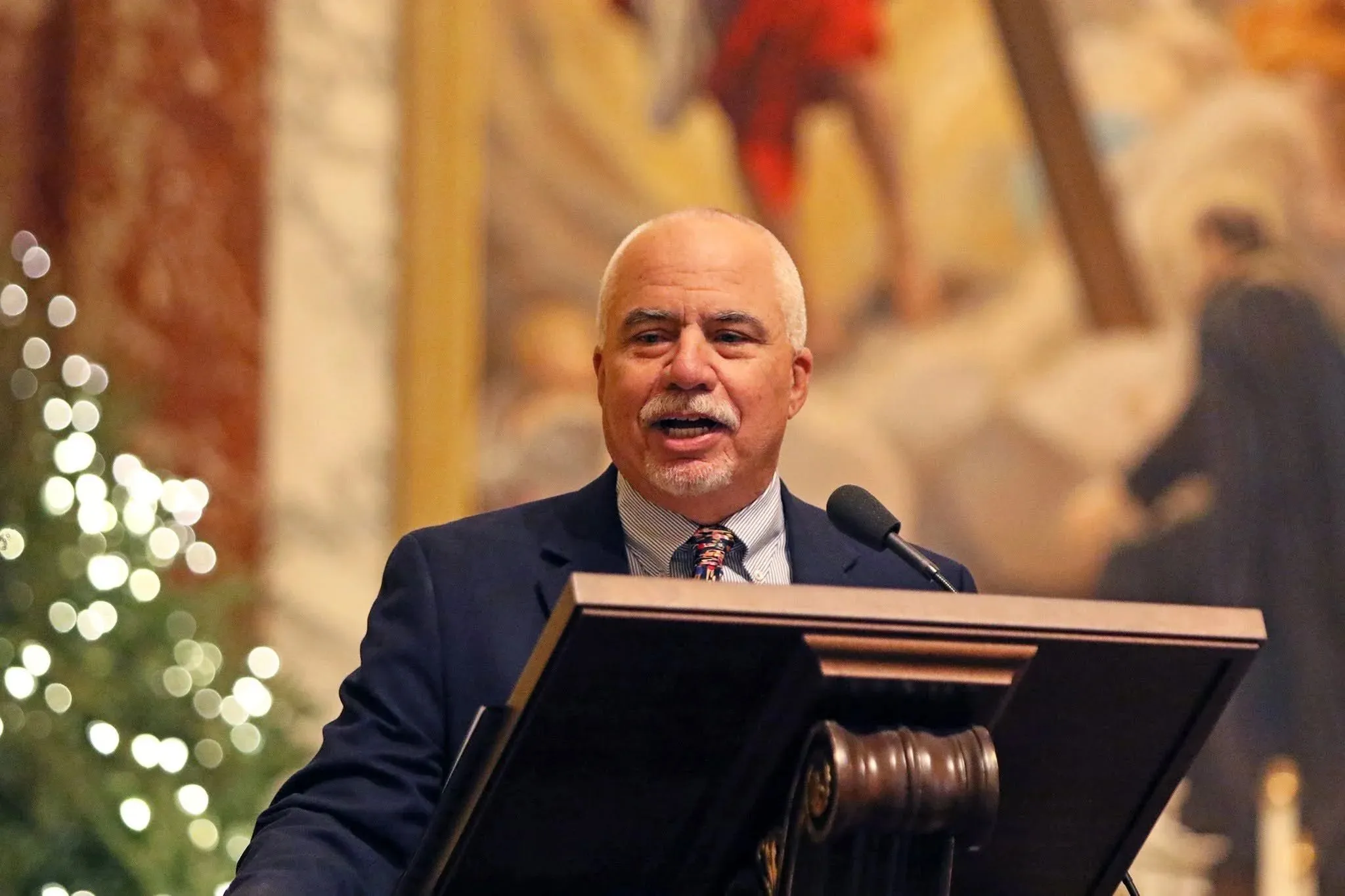 Mike Boza speaking at a podium